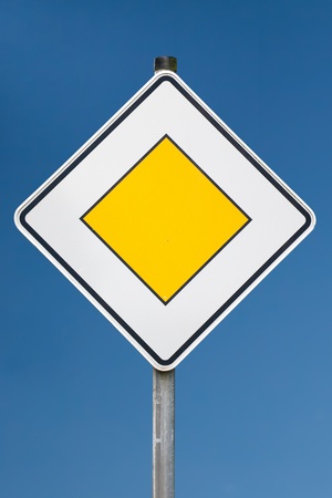 a give way sign against blue skyの写真素材