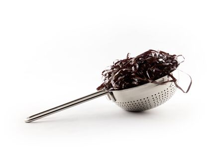 Tape cassette jam salad as spaghetti in colanderの写真素材