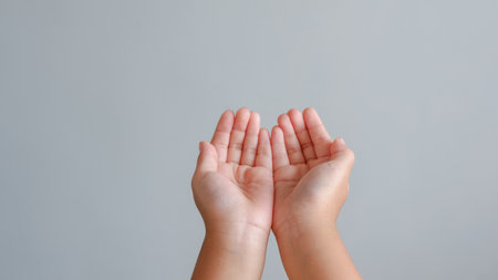 child hand. two hand empty for concept in give, help and pray isolated on grey background.の写真素材