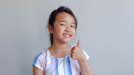 Close-up portrait of her beautiful attractive beautiful sweet curious playful cheerful smart clever girl creating new idea solution fantasizing copy space isolated gray background.の写真素材