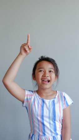 Close-up portrait of her beautiful attractive beautiful sweet curious playful cheerful smart clever girl creating new idea solution fantasizing copy space isolated gray background.の写真素材