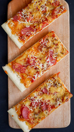Pizza with sausage and mozzarella on a wooden backgroundの写真素材