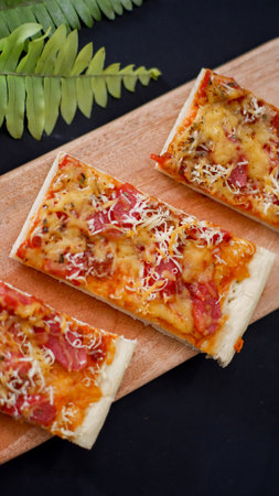 Pizza with sausage and mozzarella on a wooden backgroundの写真素材