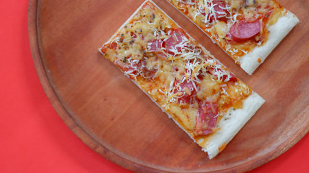 Pizza with sausage and mozzarella on a wooden backgroundの写真素材
