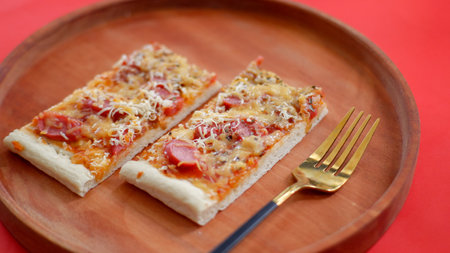 Pizza with sausage and mozzarella on a wooden backgroundの写真素材