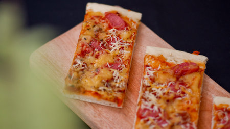 Pizza with sausage and mozzarella on a wooden backgroundの写真素材