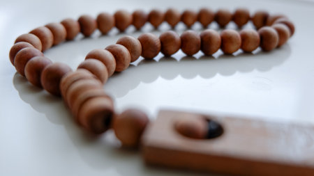 Islamic wooden prayer beads on a white floor. Design concepts on the theme of Ramadan or other Islamic religious events. Ramadan greeting card background.の写真素材