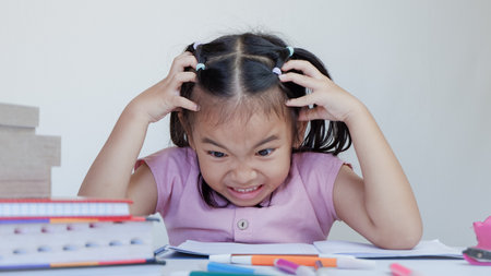 young asian girl is studying so hard. concept of brainstorming, thinking hard, failure, difficult...