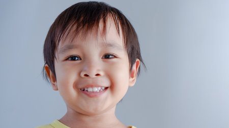 potrait of cute little asian boy wearing yellow shirtの写真素材