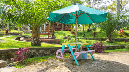 Tables and chairs in the garden of a tropical villa.の写真素材