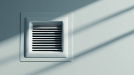 This image showcases a ventilation grate mounted on a wall, with soft shadows enhancing a tranquil and modern interior design aesthetic.の素材
