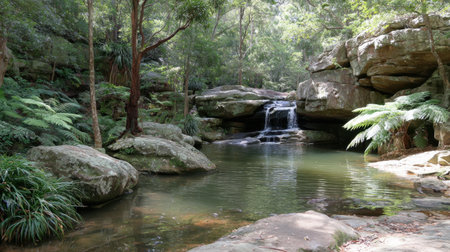 Discover a tranquil waterfall cascading into a serene pond, surrounded by lush greenery and rocky formations. This peaceful nature scene invites relaxation and exploration.の素材