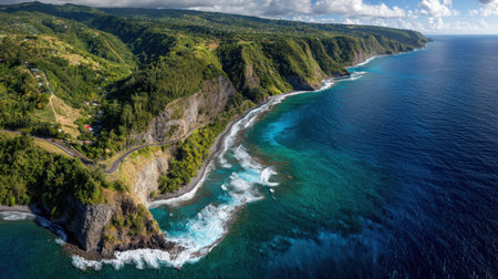 Experience the stunning beauty of a tranquil coastline captured from above, showcasing dramatic cliffs, azure waters, and vibrant greenery under a clear sky.の素材