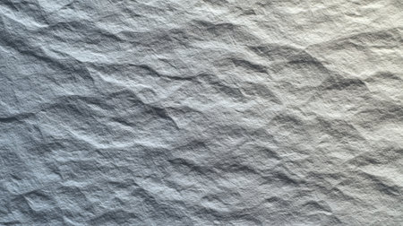 A high-quality textured gray paper background features natural creases and a rough surface, perfect for creative designs, photography, or artistic projects.の素材