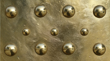 This image showcases large and small reflective gold orbs on a textured surface, creating a captivating modern artistic element perfect for backgrounds or designs.の素材