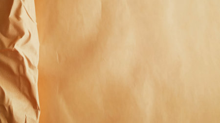This image features a textured brown paper background with a crumpled edge, perfect for various creative projects and artistic designs, providing a warm, vintage feel.の素材