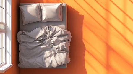 A cozy bedroom featuring soft bedding and pillows on a bed, illuminated by natural light filtering through a window with vibrant orange walls.の素材