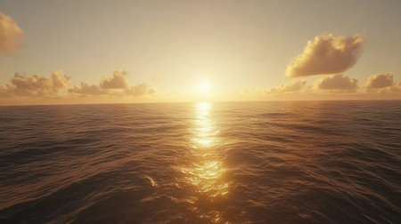 A breathtaking view of a sunset casting golden light over calm ocean waters, with soft clouds above creating a tranquil seascape. Perfect for nature lovers.の素材