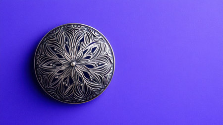 This image features a decorative round metal box with an intricate floral pattern resting on a vibrant purple background, perfect for enhancing any decor.の素材