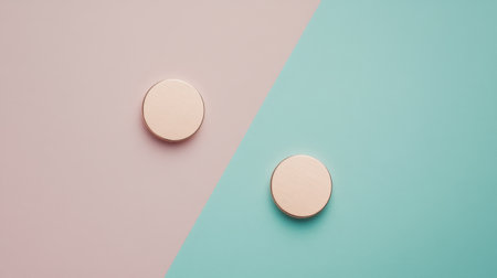 This image features two circular objects positioned against a split backdrop of soft pastel colors, showcasing modern minimalism and a stylish design aesthetic.の素材