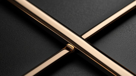 Discover a captivating close-up image of intersecting gold strips against a textured black background, perfect for modern design and elegance themes.の素材
