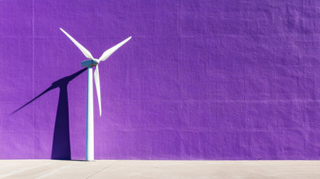 A striking white wind turbine stands against a vibrant purple wall, casting soft shadows on the concrete surface, symbolizing renewable energy and modern design.の素材