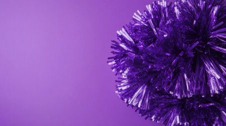This image features a vibrant purple tinsel pom pom against a smooth background, perfect for celebrating events, crafting projects, or festive decorations.の素材