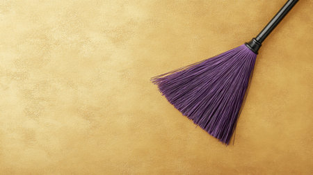 This image features a vibrant purple broom resting against a textured golden background, ideal for cleaning, home decor, or artistic projects. Perfect for modern designs!の素材