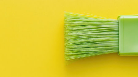 A bright green paint brush against a vibrant yellow background, perfect for creative projects, artistic expressions, and home decoration ideas.の素材