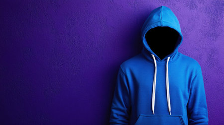 The image features a person in a vibrant blue hoodie against a striking purple background, evoking a sense of mystery and intrigue. The lack of facial features adds to the anonymity and creative artistic expression.の素材