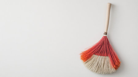 This image features a vibrant handcrafted broom with natural bristles, ideal for cleaning tasks or as a decorative piece in any home setting.の素材