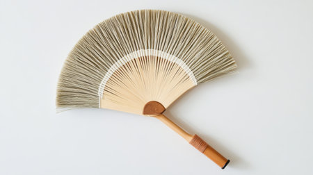 This image showcases a beautifully crafted traditional fan with a bamboo handle and natural fiber design, perfect for cultural events and home decoration.の素材