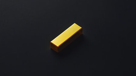A sleek golden bar sits elegantly on a dark surface, capturing light with reflections that enhance its luxurious look, perfect for financial themes.の素材