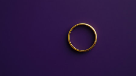 A stunning gold ring elegantly placed on a deep purple background, showcasing a perfect blend of luxury and minimalism ideal for jewelry themes.の素材