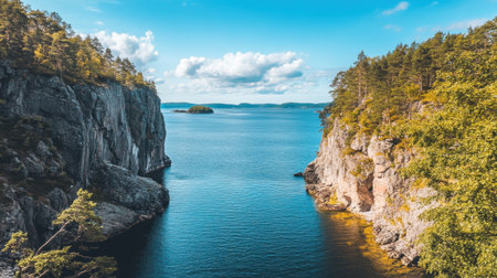 A breathtaking coastal landscape featuring rocky cliffs and tranquil blue waters under a bright, cloud-filled sky, perfect for nature enthusiasts.の素材