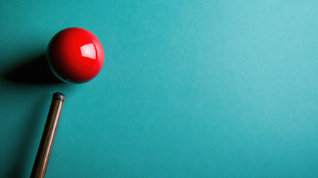 A striking image featuring a red sphere and a cue stick on a turquoise background. Ideal for themes related to sports, recreation, and minimalism.の素材