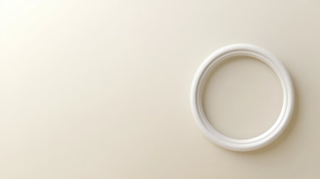 This image features a simple white circular frame set against a light beige background, ideal for minimalist design projects or artistic displays.の素材