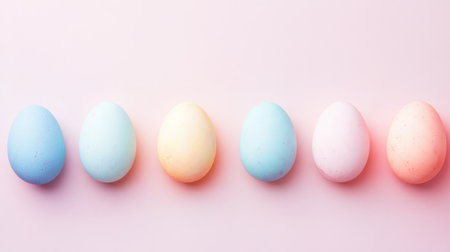 A delightful array of softly colored pastel eggs set against a gentle pink background, perfect for showcasing the spirit of Easter and spring festivities.の素材