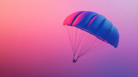 A vibrant parachute glides gracefully through a stunning sunset sky, showcasing beautiful gradient hues of pink and purple, symbolizing adventure.の素材