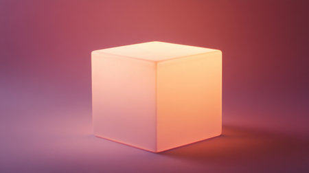 A softly glowing cube lamp radiates warm light against a smooth gradient background, perfect for enhancing modern living spaces and artistic settings.の素材