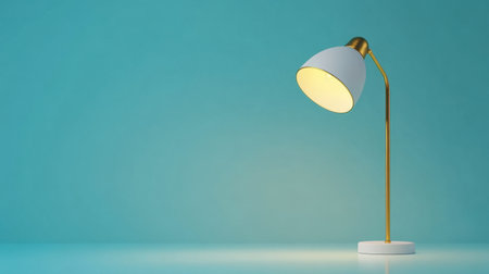 This image features a stylish modern table lamp with a gold and white design, casting a warm glow against a serene blue background, perfect for home decor.の素材