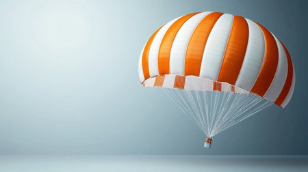 A brightly striped orange and white parachute gently floats against a light gray background, creating a dynamic visual of adventure and freedom in sky travel.の素材