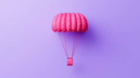 A stunning bright pink parachute suspended against a vibrant purple background creates a striking visual in minimalist style. Ideal for creative projects.の素材