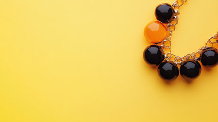 This vibrant statement necklace features glossy black and an orange bead on a bright yellow backdrop. A perfect accessory for bold fashion.の素材