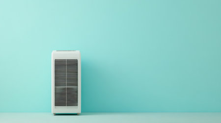 This image features a modern portable air conditioner positioned against a light blue wall, ideal for enhancing comfort and style in both home and office settings.の素材