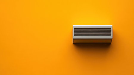 This image features a stylish air conditioner unit mounted on a vibrant yellow wall, enhancing modern home interiors. The bright hue adds warmth and energy, perfect for design inspiration.の素材