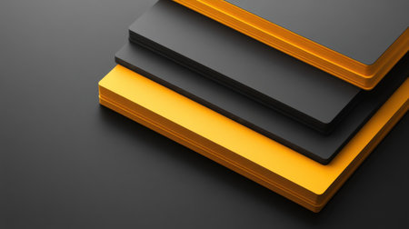 A visually appealing stack of black and yellow notebooks arranged on a dark surface, perfect for creative projects, professional workspace decor, and study essentials.の素材