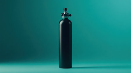 A sleek black gas cylinder stands against a turquoise background, ideal for industrial and safety-related visuals in various design projects.の素材