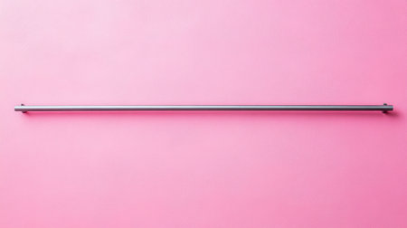 A sleek metal bar placed against a vibrant pink background, symbolizing modern design and minimalism. Ideal for art and decor projects.の素材