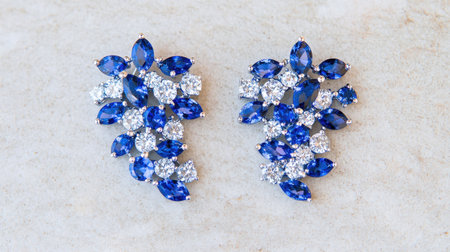 Beautifully crafted earrings featuring vibrant blue gemstones and sparkling diamond accents, perfect for adding a touch of elegance and glamour.の素材